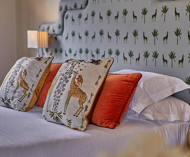 The Retreat interior shot of Day Room giraffe-inspired headboard | Giraffe Manor | Planet Africa Safaris tailormade safari itineraries in Kenya and beyond
