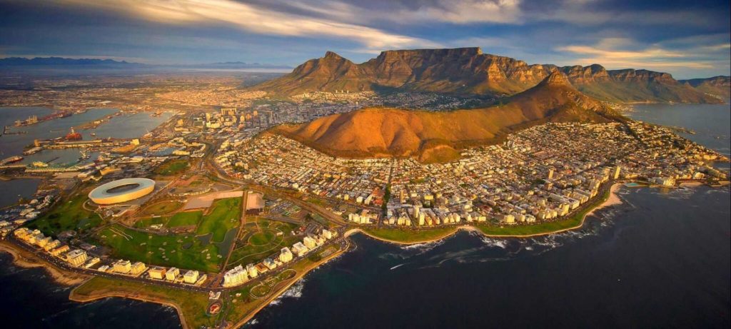 Aerial image of cosmopolitan Cape Town surrounded by the Atlantic Ocean. Table mountain, the city and the Greenpoint stadium can be seen | Planet Africa Safaris | Blog