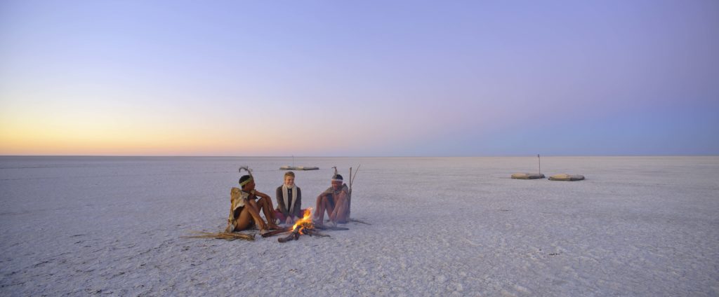 Image of a guest and 2 locals enjoying the salt pans at Meno-A-Kwena in the Makgadikgadi Pans National Park in Botswana | Planet Africa | Blog | Meno-A-Kwena