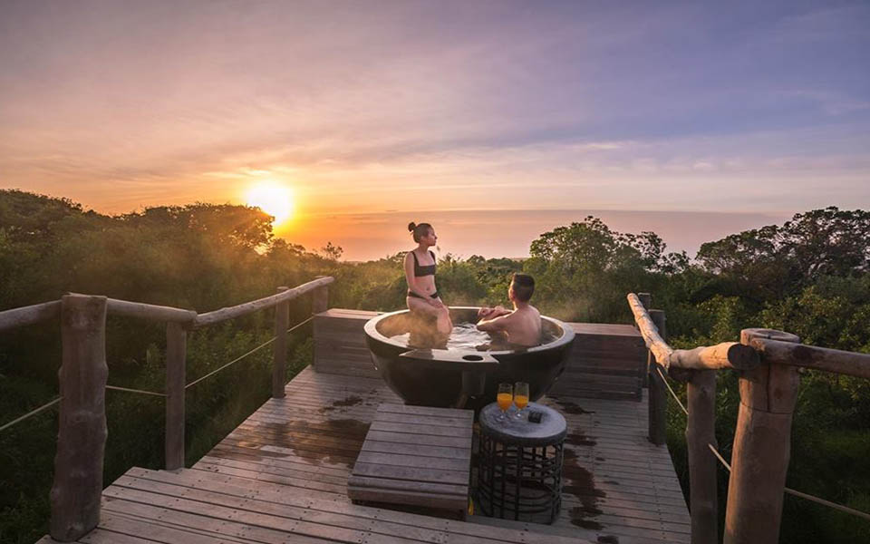 Image of a couple gazing out on the bush while in the hot tub at the Highlands honeymoon suite in northern Tanzania | Planet Africa Safaris | Blog | Jason Wang via Asilia Africa
