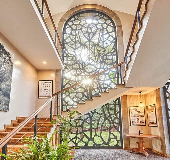 The Retreat interior shot of giraffe window and staircase | Giraffe Manor | Planet Africa Safaris tailormade safari itineraries in Kenya and beyond