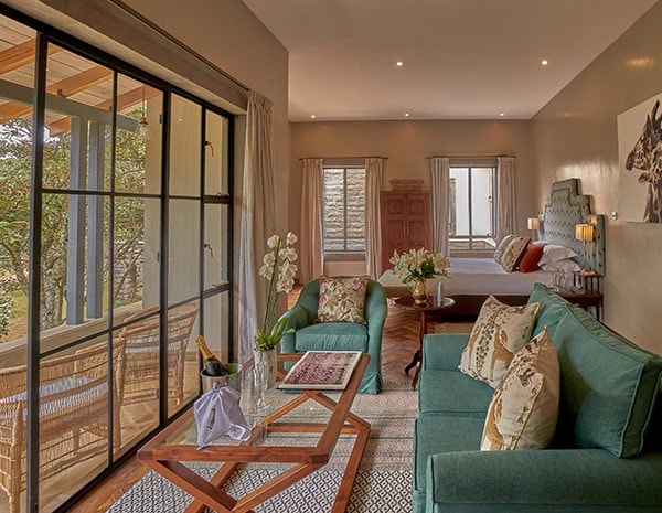 The Retreat interior shot of Day Room and patio | Giraffe Manor | Planet Africa Safaris tailormade safari itineraries in Kenya and beyond