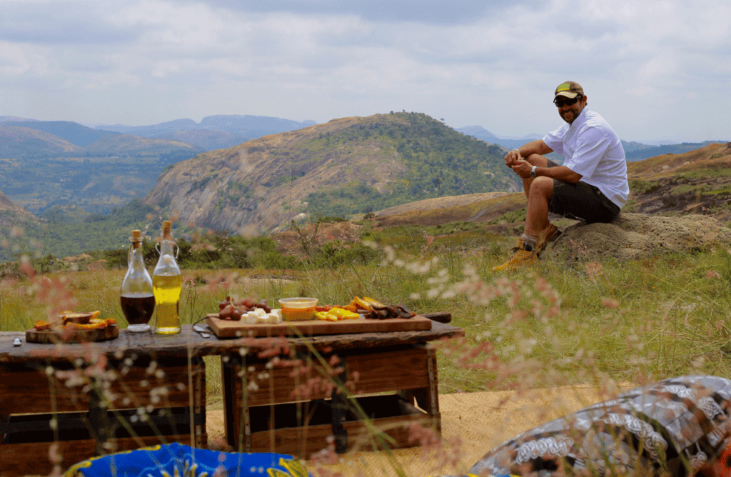 Image of the Safari Butler with a private dining feast laid out in Victoria Falls | Planet Africa Safaris | Blog | The Safari Butler