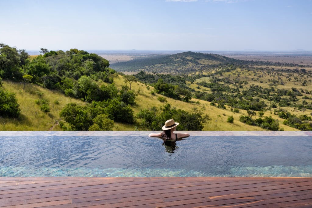 Image showing woman enjoying safari in Tanzania's Serengeti while at pool at Singita Sasakwa Lodge | Planet Africa Safaris | Blog